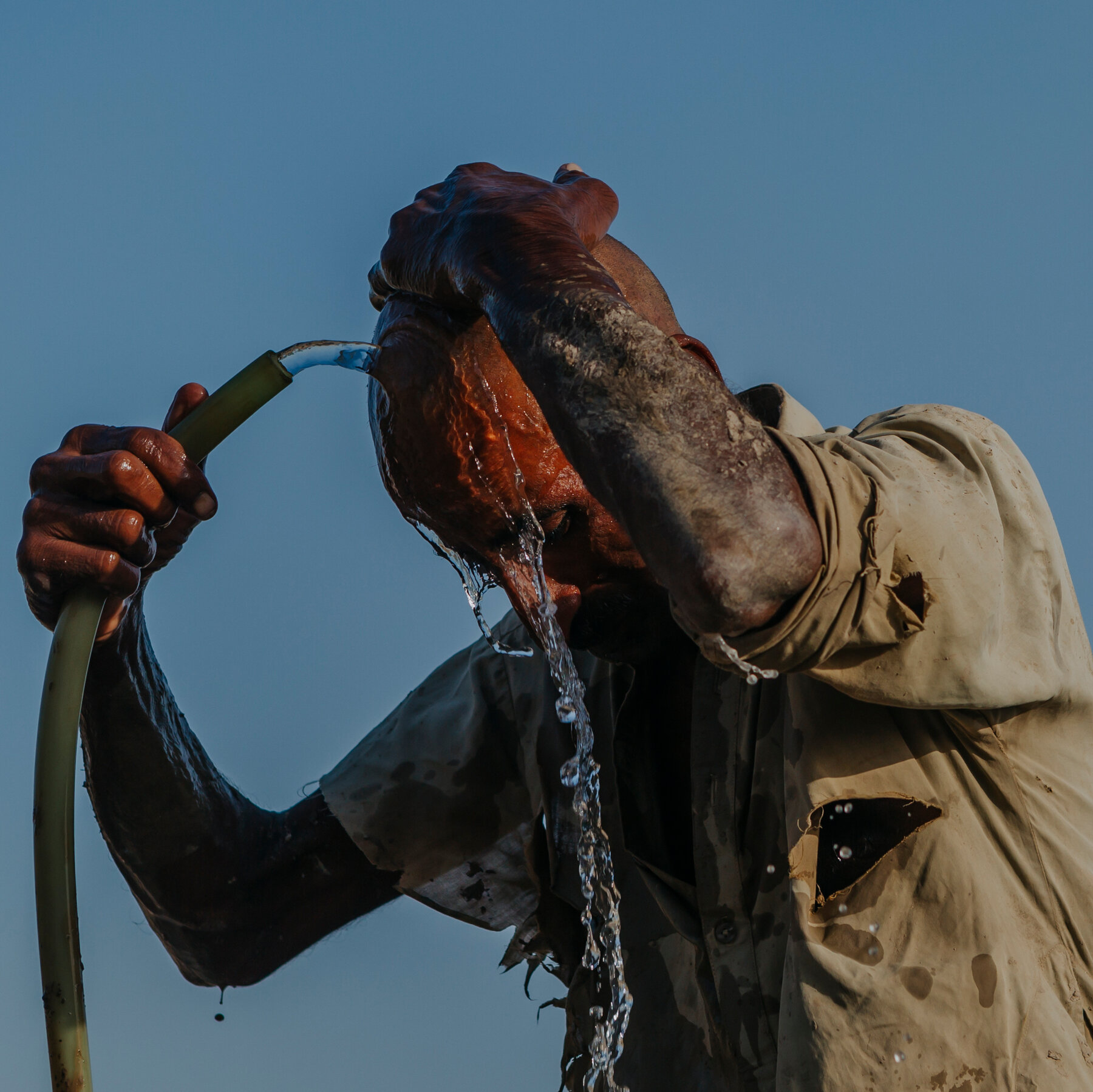 Residents of Dadu District, Pakistan, Seek Shade Amid 125°F Heat